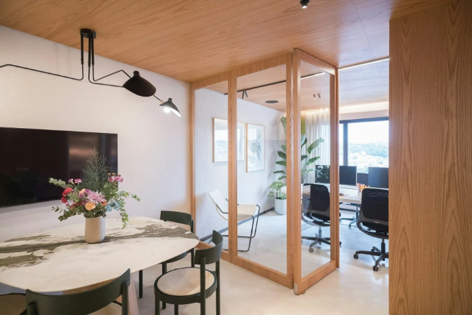 Modern office interior with meeting area and workstations.
